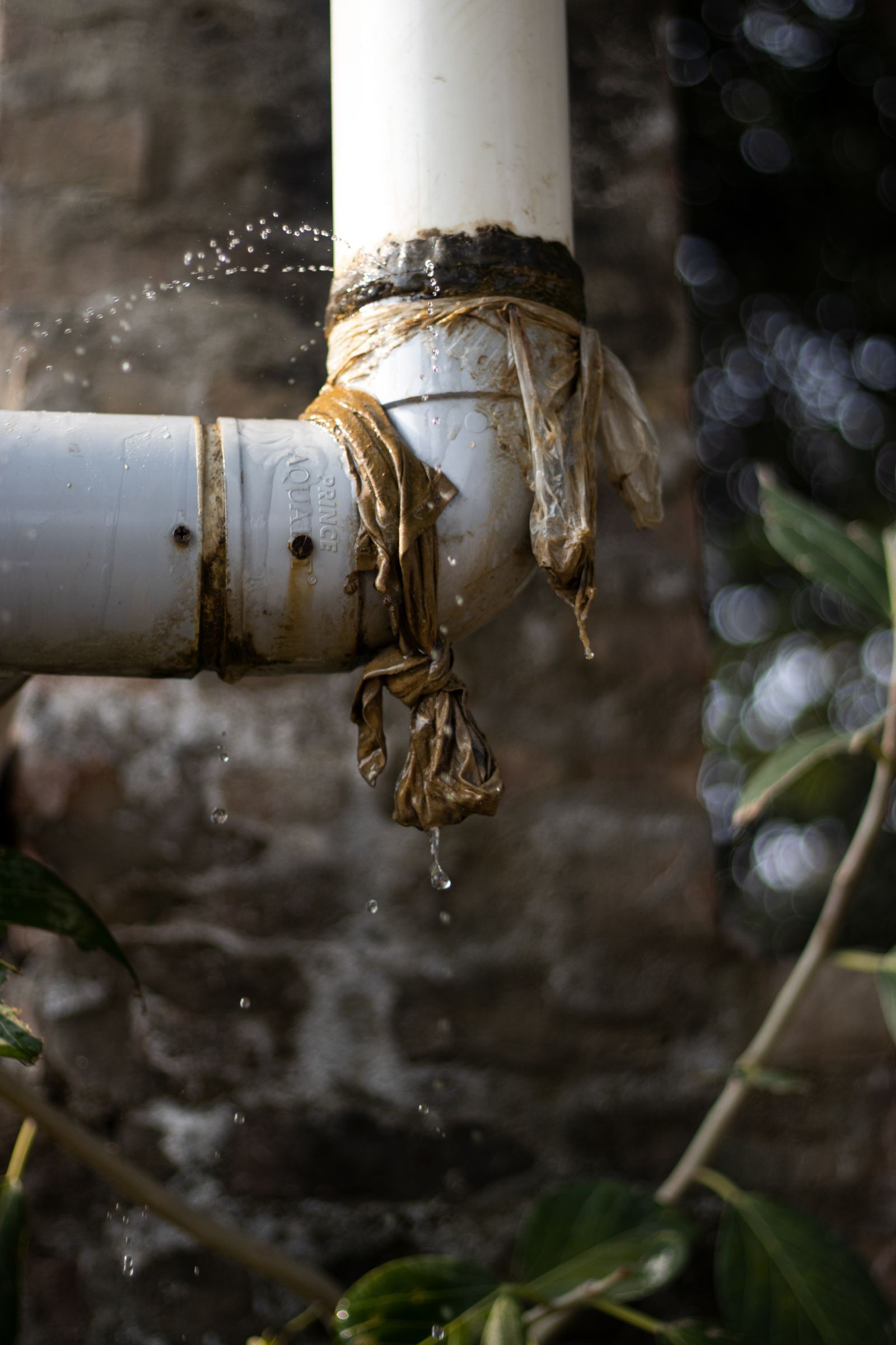 Water dripping from a wrapped, leaking pipe joint